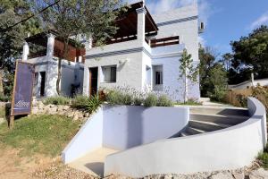 a white house with a ramp in front of it at Alma de La Pedrera - in La Pedrera