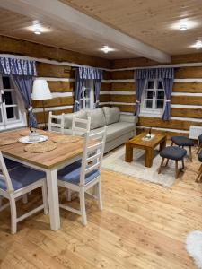 a living room with a table and a couch at Chalupa pod jelení skálou in Dolni Dvur