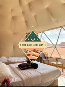 a sign that says moon desert luxury camp on a bed at Moon Desert Luxury Camp in Wadi Rum