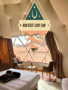 a bedroom with a bed and a window with the moon desert luxury camp at Moon Desert Luxury Camp in Wadi Rum +46 photos