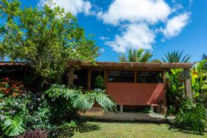a house in a garden with trees and plants at Bhoga Forest 