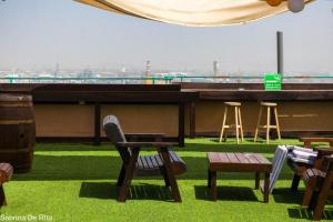 a table and chairs on the roof of a building at City Center Apartments in Haifa