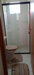 a bathroom with a toilet and a glass shower at Apartamento Próximo a Arena Pantanal in Cuiabá +7 photos