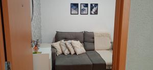 a couch with pillows on it in a room at Apartamento Próximo a Arena Pantanal in Cuiabá