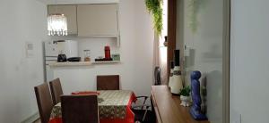 a kitchen with a table and a dining room at Apartamento Próximo a Arena Pantanal in Cuiabá