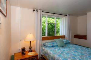 a bedroom with a bed and a window at Bhoga Forest 