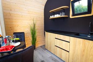a kitchen with a table and a counter top at Woodydrem in Hruštín