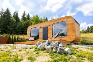 a wooden house with large windows in a field at Woodydrem in Hruštín