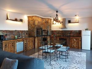 a kitchen with a glass table and some chairs at Casa do Outeiro in Arcos de Valdevez