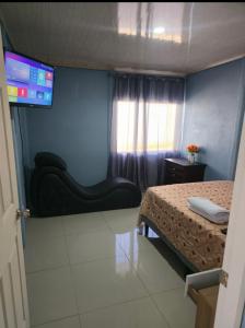 a room with two beds and a tv on the wall at Apartamentos DesCANso in Comunidad +4 photos