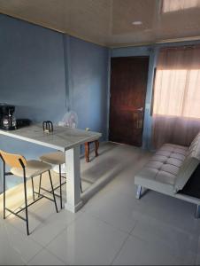a dining room with a table and chairs and a couch at Apartamentos DesCANso in Comunidad