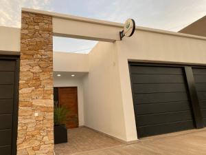 a garage with two garage doors and a clock at Aires del Rio Apart in Villa de Soto