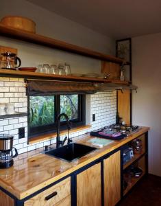 a kitchen with a sink and a counter top at Libra Eco-Adventure Hostel in El Pescadero
