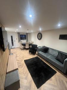 a living room with a couch and a table at Caledonian Lock House in Caol