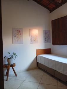a bedroom with a bed and a potted plant at Casa Beija Flor in Itacaré