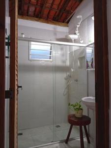 a bathroom with a glass shower and a sink at Casa Beija Flor in Itacaré +4 photos