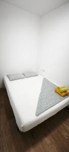 a white bed sitting on top of a wooden floor at Playa de Sant Adrià de Besòs in Sant Adria de Besos +13 photos