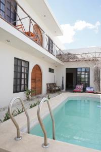 a swimming pool in the backyard of a house at Casa Calandria in Chicxulub