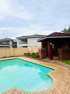 een zwembad voor een huis bij 12th on The Bay in Richards Bay