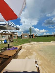a patio with a table and an umbrella at Brisas De Las Sierras in Villa Ciudad Parque +23 photos