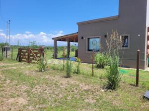 a house with a fence in front of it at Brisas De Las Sierras in Villa Ciudad Parque
