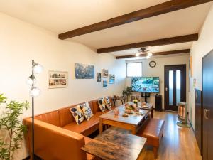 a living room with a couch and a table at ゲストハウス海と石 in Takamatsu