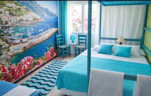 a room with two beds and a painting of a beach at Can Pau Llanca Sf Parascheva in Llança