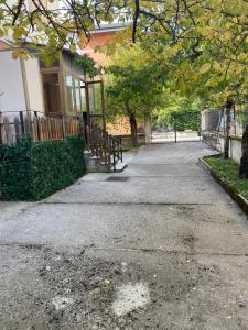 a sidewalk in front of a house with a fence at Chalet Mary Roccaraso in Roccaraso