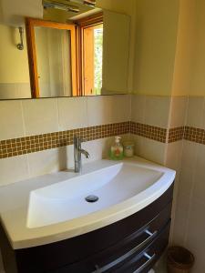 a white sink in a bathroom with a mirror at Chalet Mary Roccaraso in Roccaraso