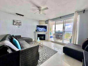 a living room with a couch and a fireplace at Oceanfront Rosarito Balcony Beach & Amazing Sunsets in Rosarito Beach