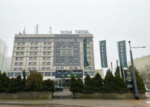 a hotel building with signs in front of it at B&B HOTEL Tychy in Tychy