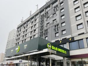 a large building with a sign in front of it at B&B HOTEL Tychy in Tychy +1 photo