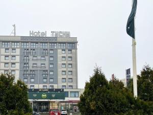 a hotel with a sign on top of a building at B&B HOTEL Tychy in Tychy