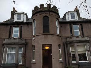 an old brick house with a tower on top of it at The Limes Guesthouse Montrose in Montrose