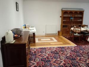 a room with a kitchen with a counter and a rug at The Limes Guesthouse Montrose in Montrose