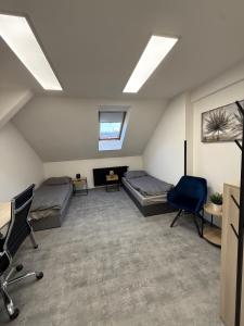 een slaapkamer op zolder met 2 bedden en een bureau bij Teplice accommodation in Teplice