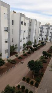 an empty street in front of a large building at NAYA apartment in Fez +10 photos