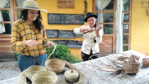 two women standing in front of a table with baskets at Jacamaki- Eco-lodge & Reserva Natural in Villa de Leyva +84 photos