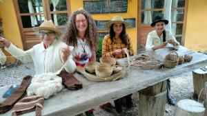 a group of women sitting at a table with baskets at Jacamaki- Eco-lodge & Reserva Natural in Villa de Leyva