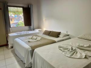 En eller flere senge i et værelse på Pousada Campo Verde