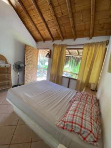 un grande letto in una stanza con finestre di Habitaciones en Vichayito a Vichayito