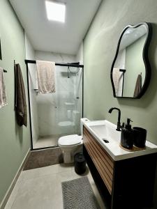 a bathroom with a shower and a toilet and a sink at Refugio 890 in Tubarão +75 photos