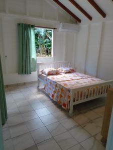 a bedroom with a bed in a room with a window at Brada Gites2 in Deshaies