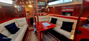 a small room with couches and a table in it at Voilier de tout confort in Cherbourg en Cotentin