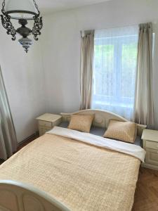 a bedroom with a large bed and a window at White Haven in Chřibská