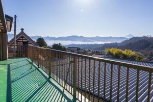 a balcony of a house with a view of the mountains at FUJIMI Place in Yamanashi