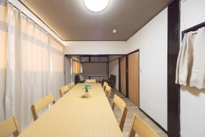 a conference room with a long table and chairs at FUJIMI Place in Yamanashi