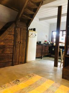 a kitchen with a white refrigerator in a room at Casa Praia in Palhoça