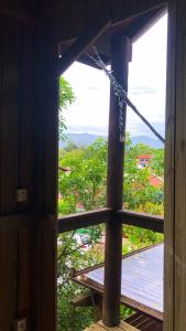 an open window of a building with a view at Casa Praia in Palhoça +1 photo