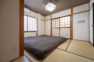 a bedroom with a bed in a room with windows at FUJIMI Place in Yamanashi +73 photos